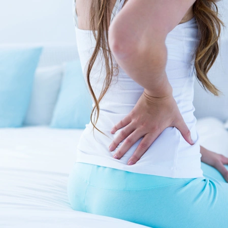 Person Holding Lower Back Due To Back Pain