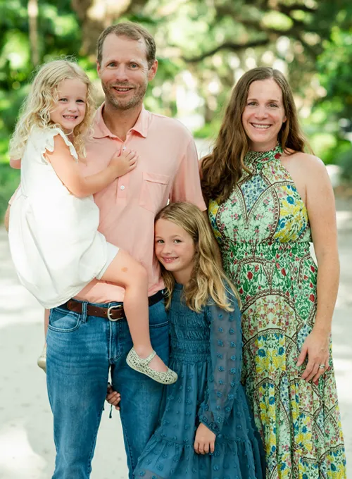 Family Portrait Outdoors Featuring Two Adults And Two Children